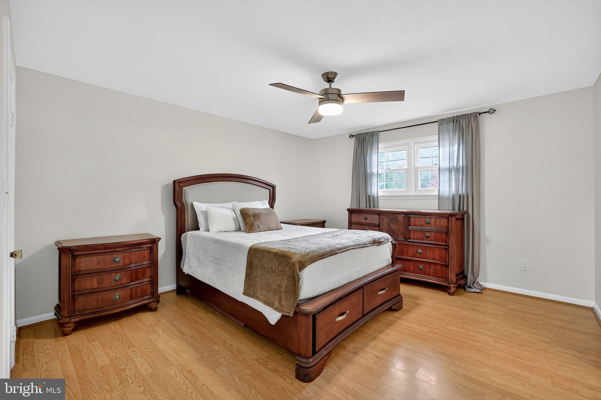 1716 Gayfields Drive Silver Spring, MD 20906 - Photo 31 of 55 a bedroom with a bed and a chandelier