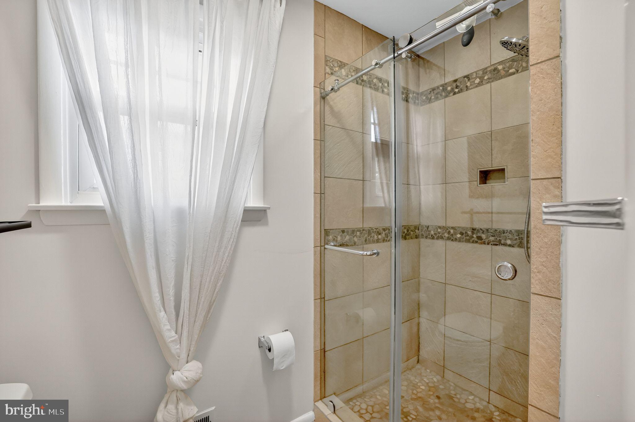 1716 Gayfields Drive Silver Spring, MD 20906 - Photo 34 of 55 a bathroom with a shower and a window