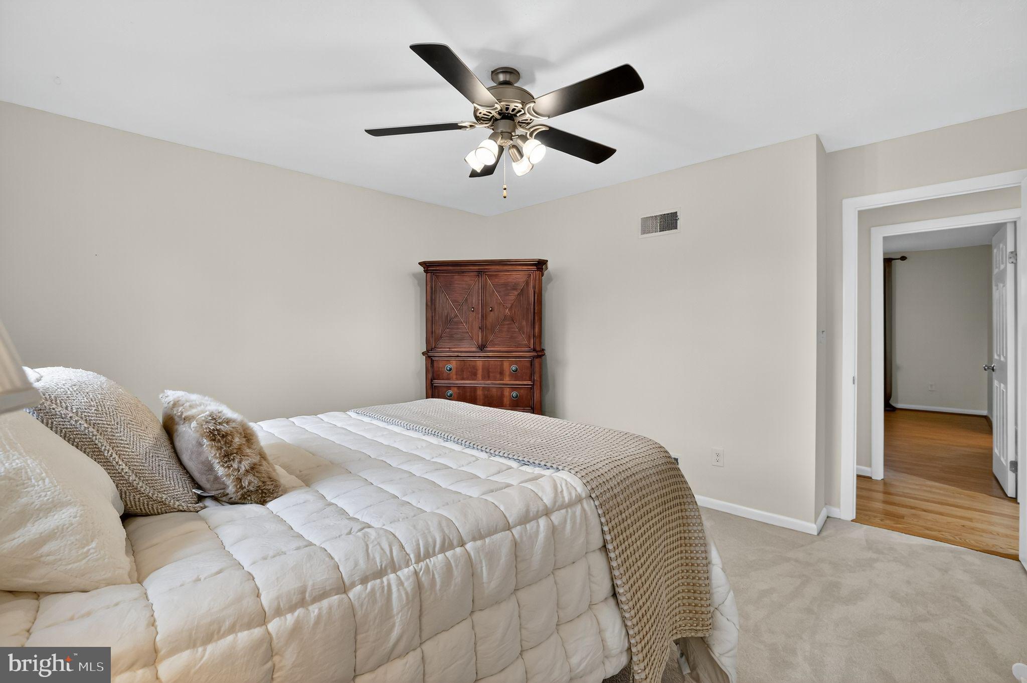 1716 Gayfields Drive Silver Spring, MD 20906 - Photo 38 of 55 a bedroom with a large bed and a ceiling fan