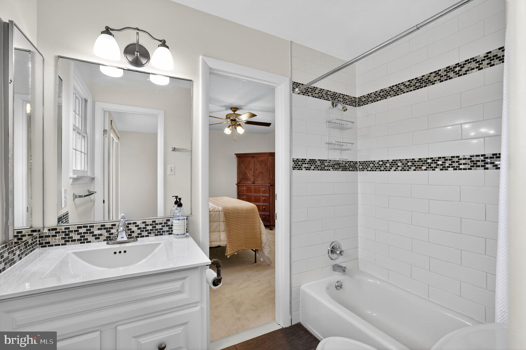1716 Gayfields Drive Silver Spring, MD 20906 - Photo 39 of 55 a bathroom with a sink a mirror and a shower