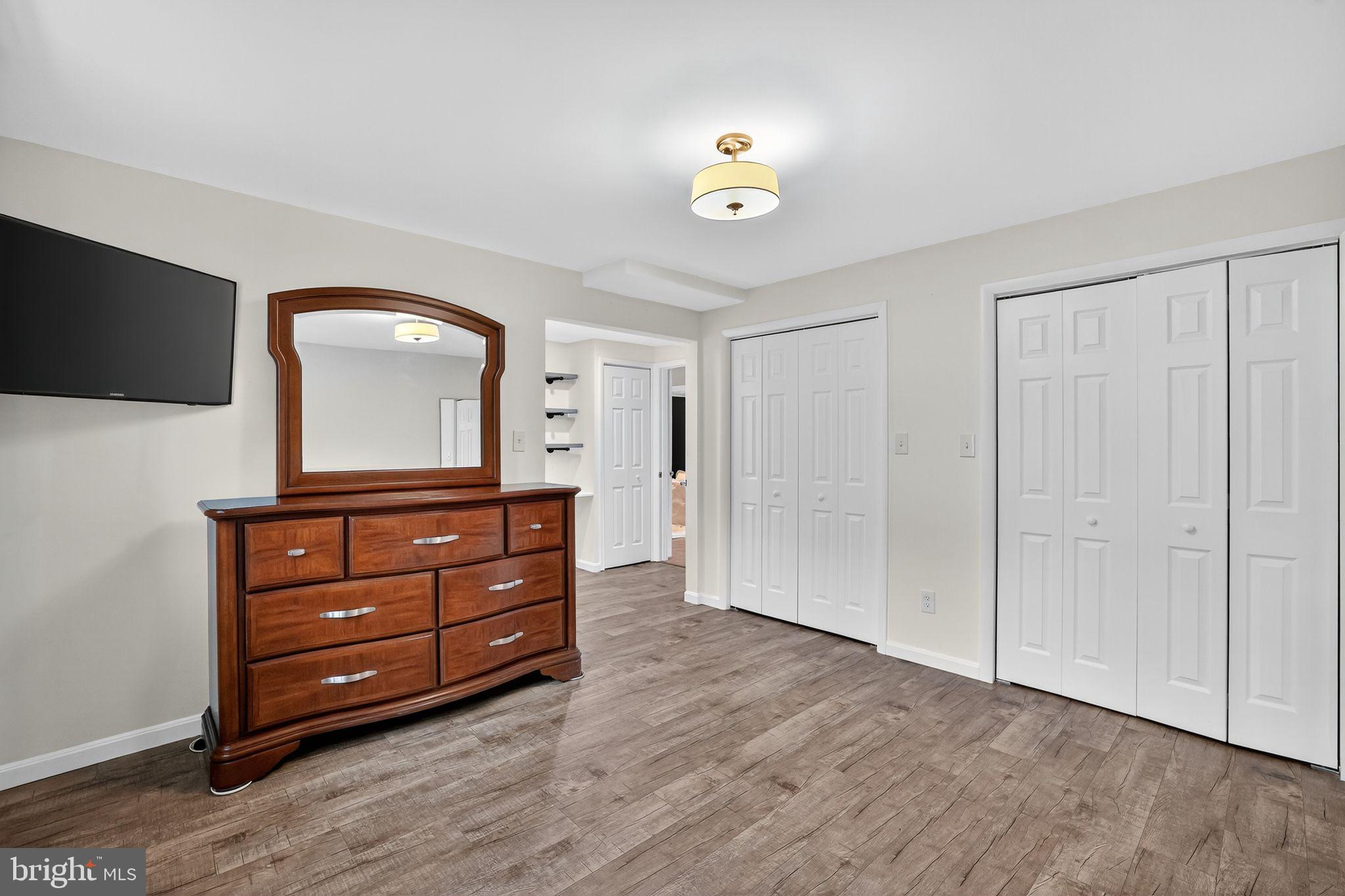 1716 Gayfields Drive Silver Spring, MD 20906 - Photo 52 of 55 a room with a dresser and a mirror