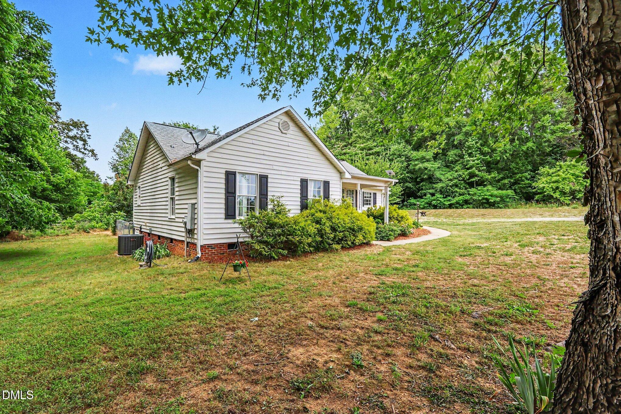 1750 Tom Oakley Road Timberlake, NC 27583 - Photo 2 of 31 a view of a house with a yard and sitting area