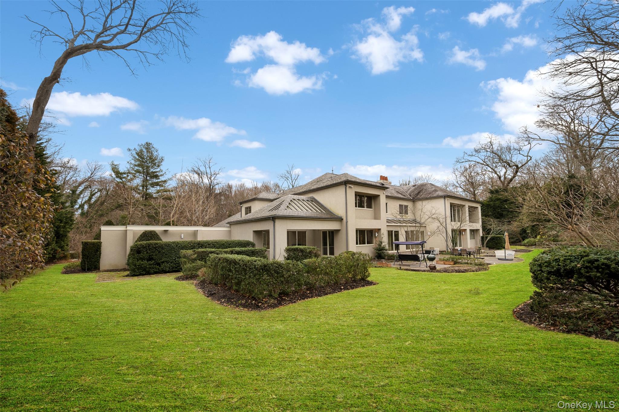 121 Piping Rock Road Locust Valley, NY 11560 - Photo 14 of 14 a front view of a house with garden