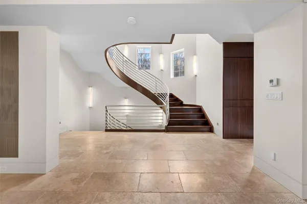 a view of a livingroom with stairs and furniture