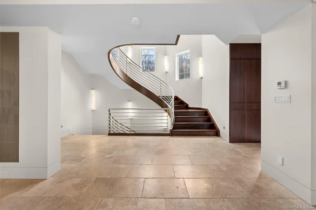a view of a livingroom with stairs and furniture