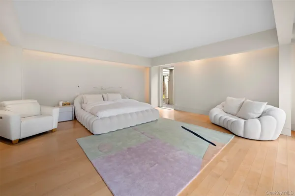 a spacious bedroom with a bed and couch