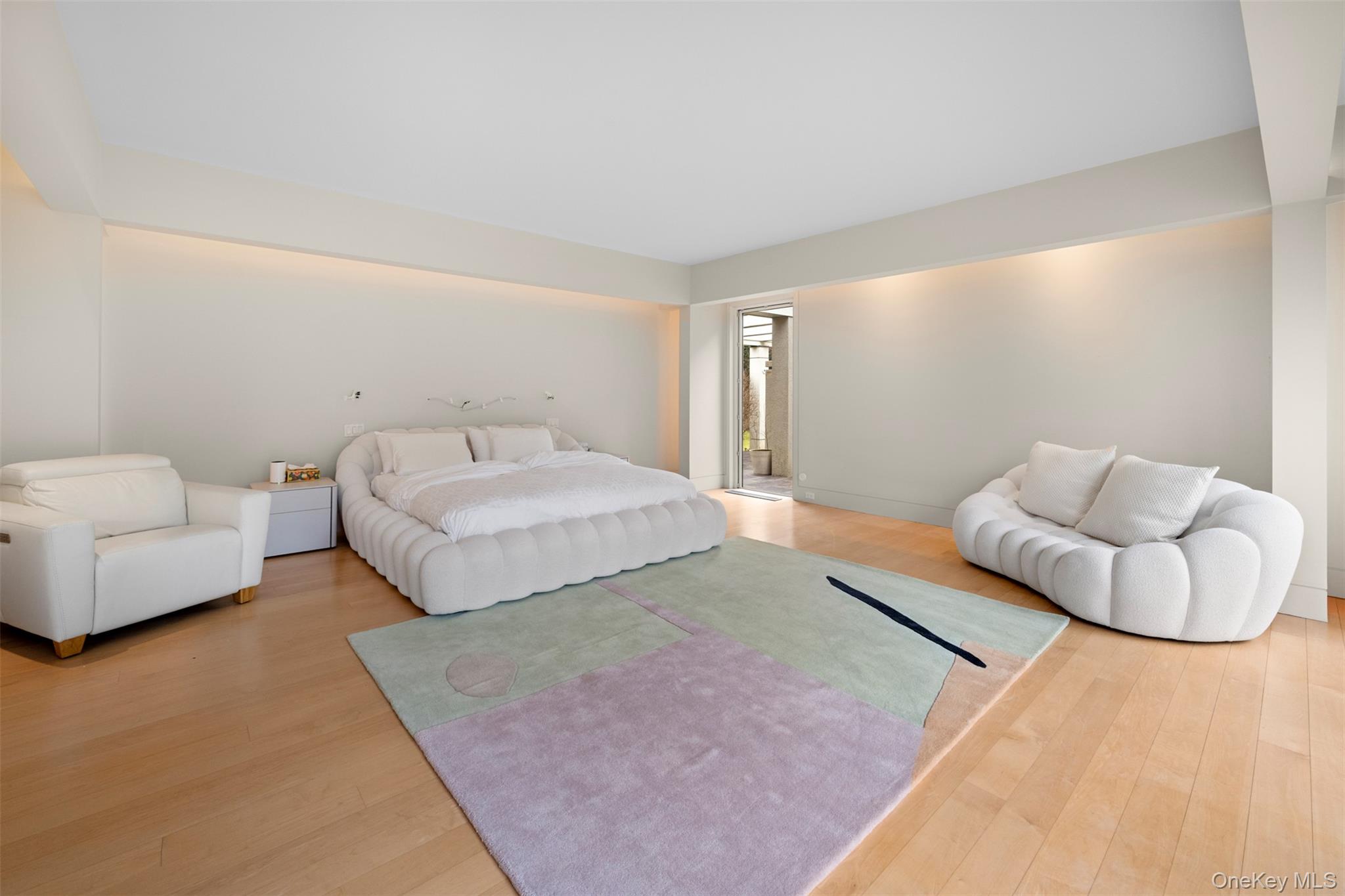 121 Piping Rock Road Locust Valley, NY 11560 - Photo 9 of 14 a spacious bedroom with a bed and couch