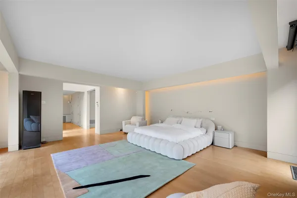 a spacious bedroom with two beds and painted walls