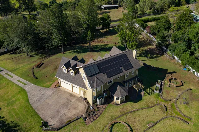 an aerial view of a house having swimming pool