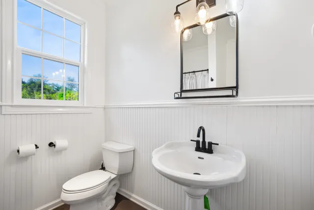 a bathroom with a sink a mirror and a toilet