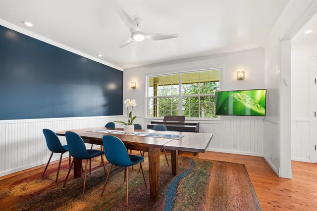a very nice looking dining room with a large window
