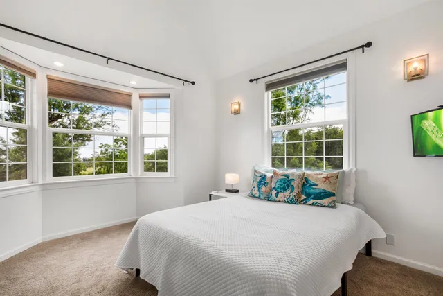 a bedroom with a large bed and a window