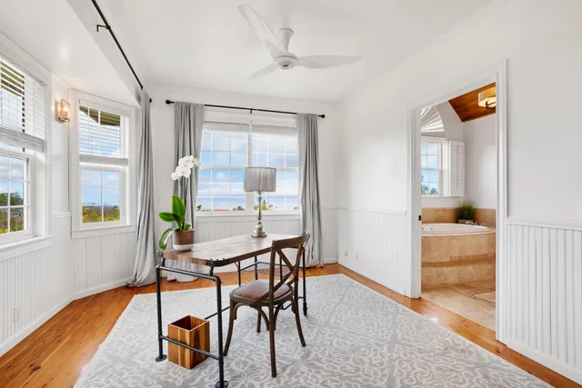 a view of a dining room with furniture and a window