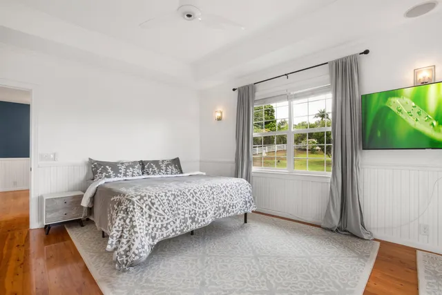 a bed sitting in a bedroom next to a window