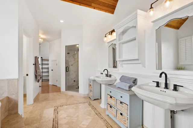 a bathroom with double vanity sink and a mirror