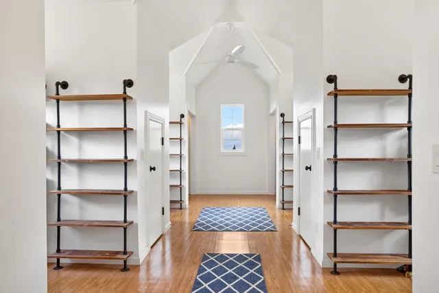 a view of walk in closet with empty racks