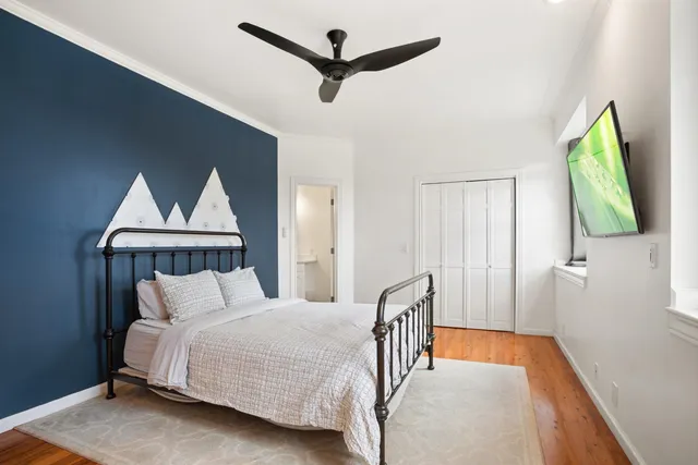 a bedroom with a bed and a chandelier