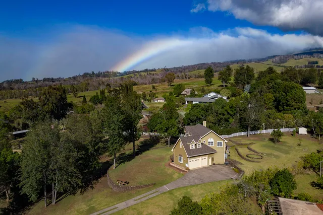 an aerial view of a house with a yard
