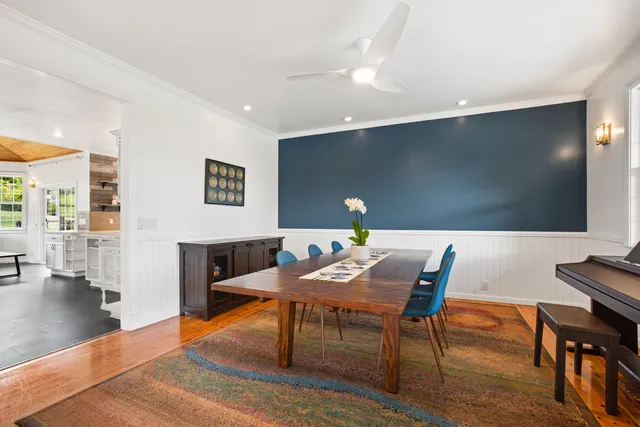 a view of a dining room with furniture and wooden floor