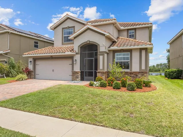 a front view of a house with a yard and garage