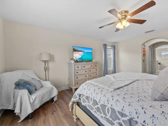 a bedroom with a bed and a chandelier