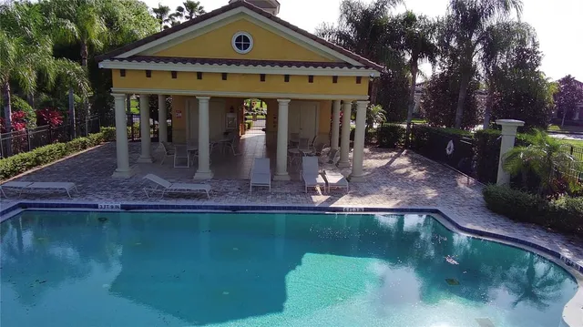 an aerial view of a house with a yard and lake view in back