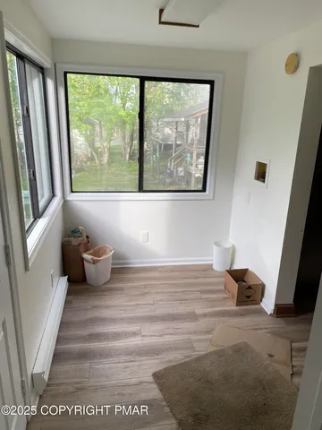 a room with wooden floor and a window