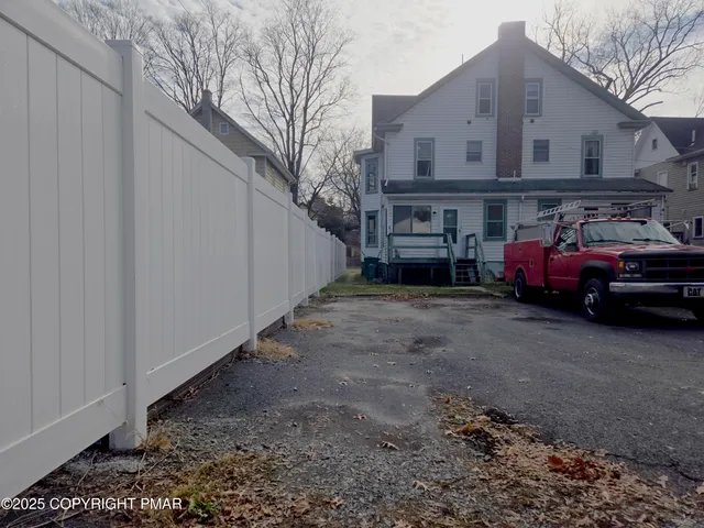 a view of a car park in front of house