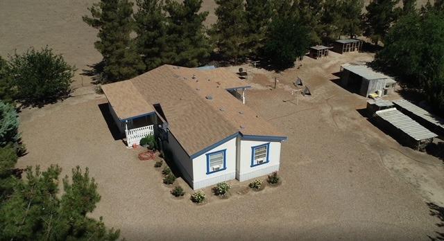 an aerial view of a house with yard and parking space