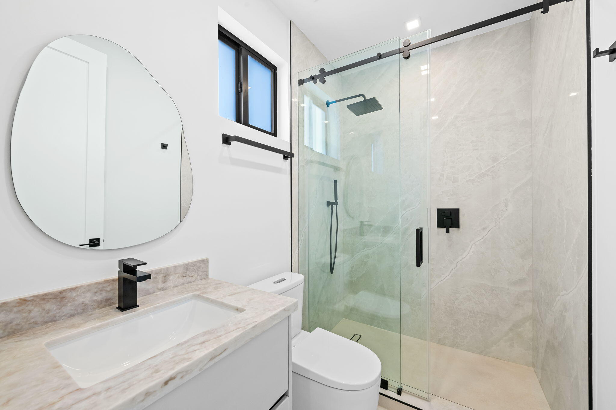 2324 Southwest 26th Street Miami, FL 33133 - Photo 33 of 45 a bathroom with a sink toilet a mirror and shower