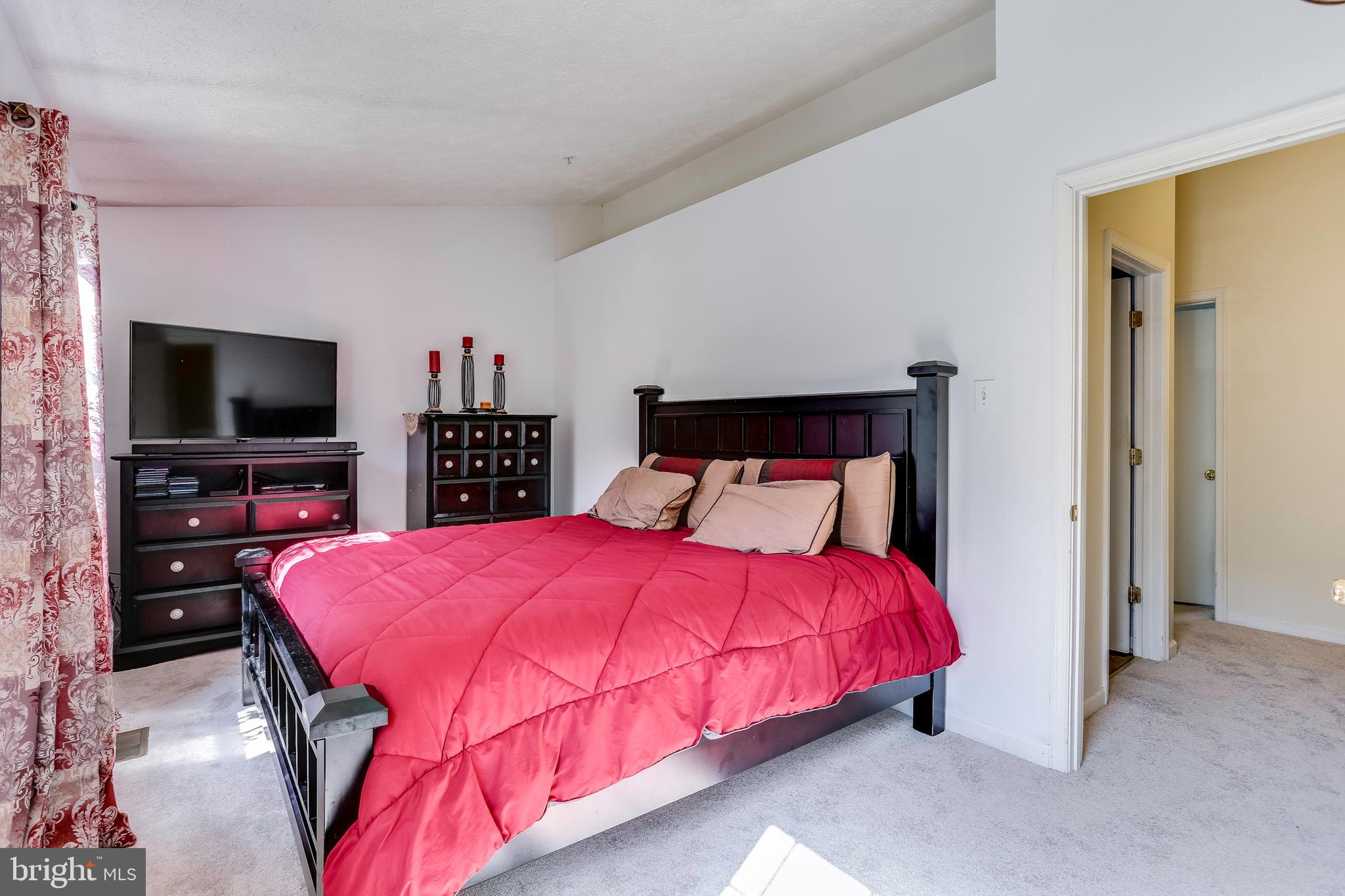 2075 Paperbark Road Baltimore, MD 21221 - Photo 9 of 22 a bedroom with a bed and a flat screen tv