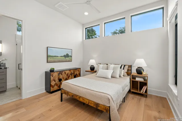 a bathroom with a granite countertop sink a toilet and a mirror