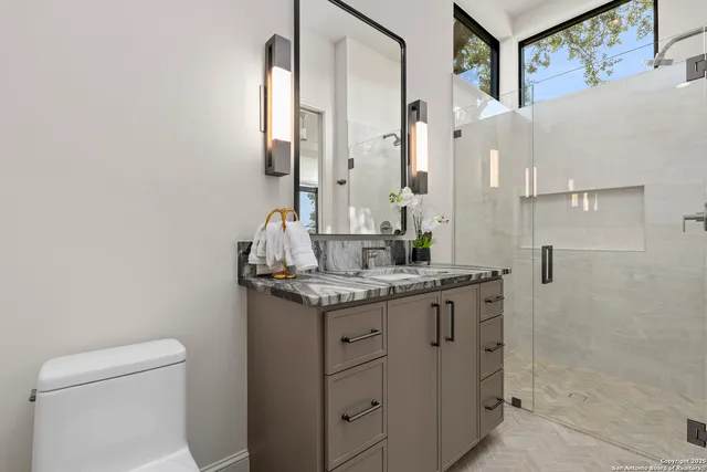 a bedroom with a bed and a mirror