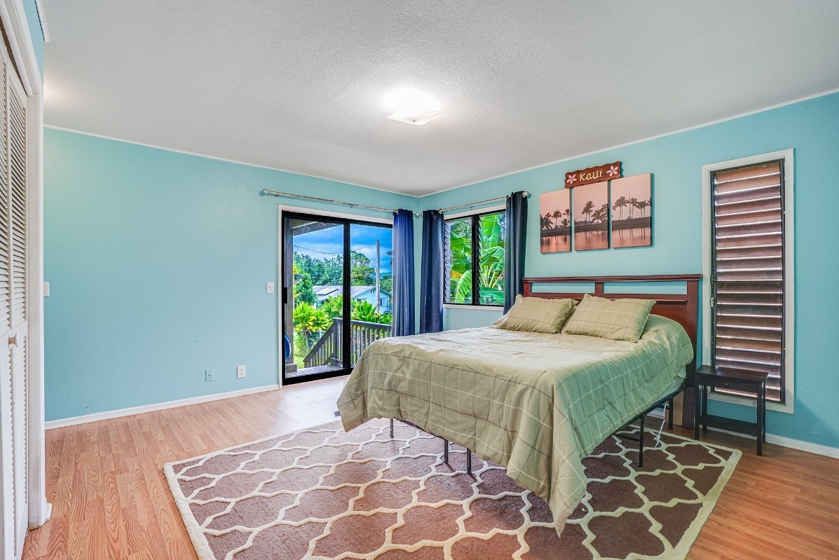 5890 Lokelani Road, Unit 2 Kapaa, HI 96746 - Photo 14 of 29 a bedroom with a large bed and a window