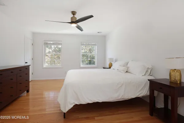 a large bed sitting in a bedroom next to a window