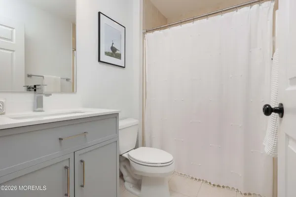 a bathroom with a sink mirror and toilet