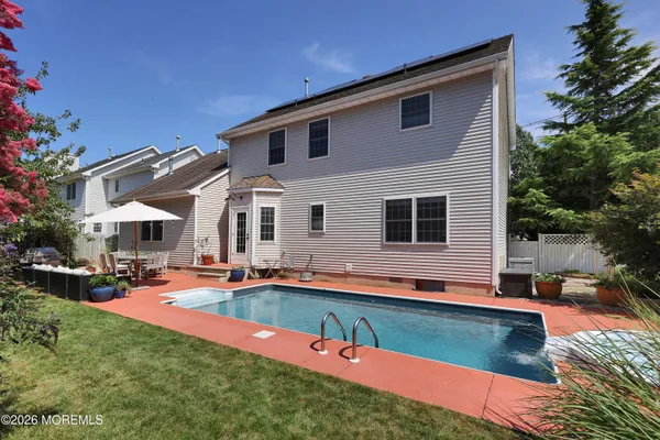 a front view of house with yard and outdoor seating
