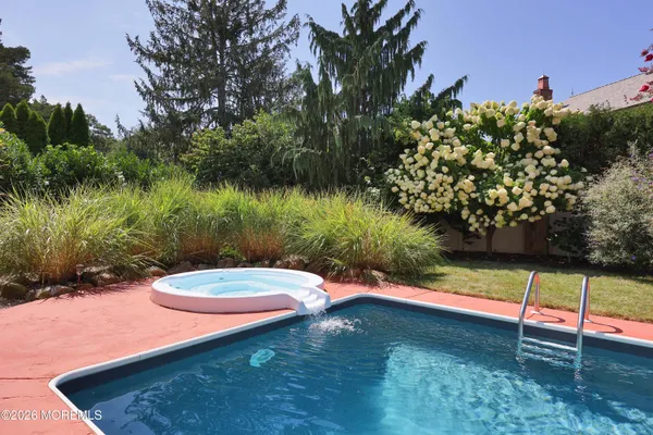a view of swimming pool with a table and chairs