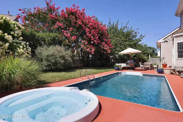 a view of a backyard with swimming pool