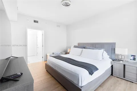 a large white bed in a white room