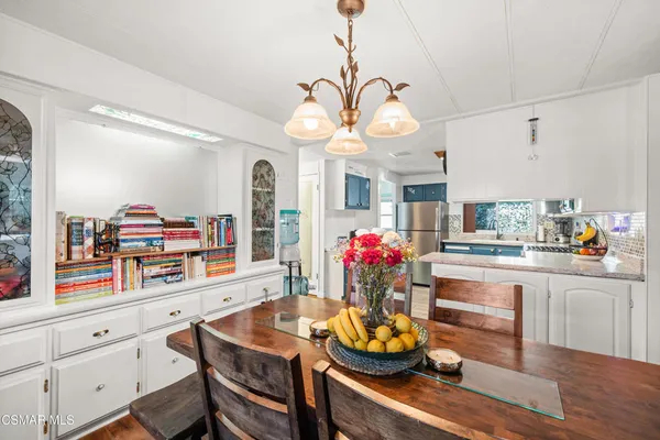 a kitchen with a table and chandelier