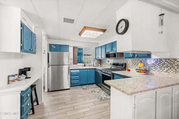 a kitchen with a refrigerator a stove top oven a sink and dishwasher