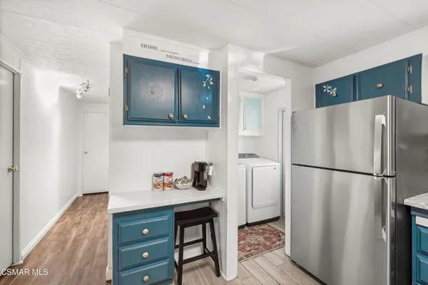 a white refrigerator freezer sitting in a kitchen