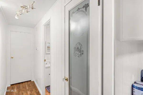 a view of a hallway with a door