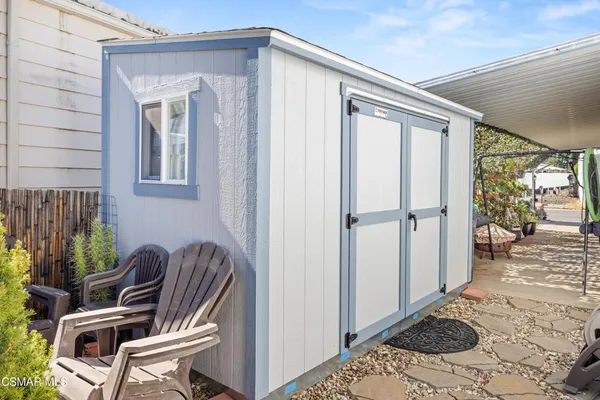 a view of two chairs in the balcony