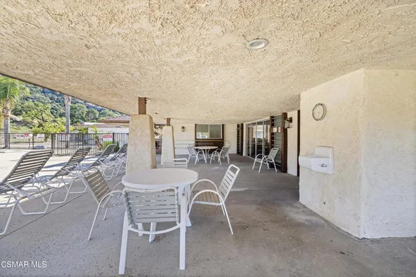 a dining room with furniture and a floor to ceiling window
