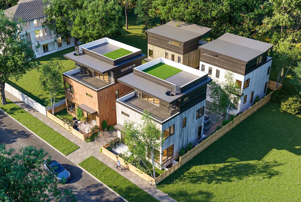 an aerial view of residential houses with yard