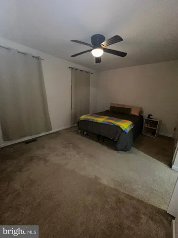 a living room with furniture and chandelier