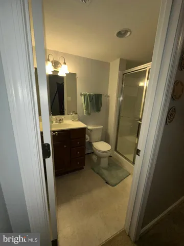 a bathroom with sink a mirror a toilet and vanity
