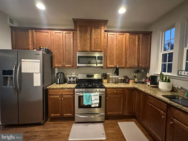 a kitchen with a sink stove and refrigerator